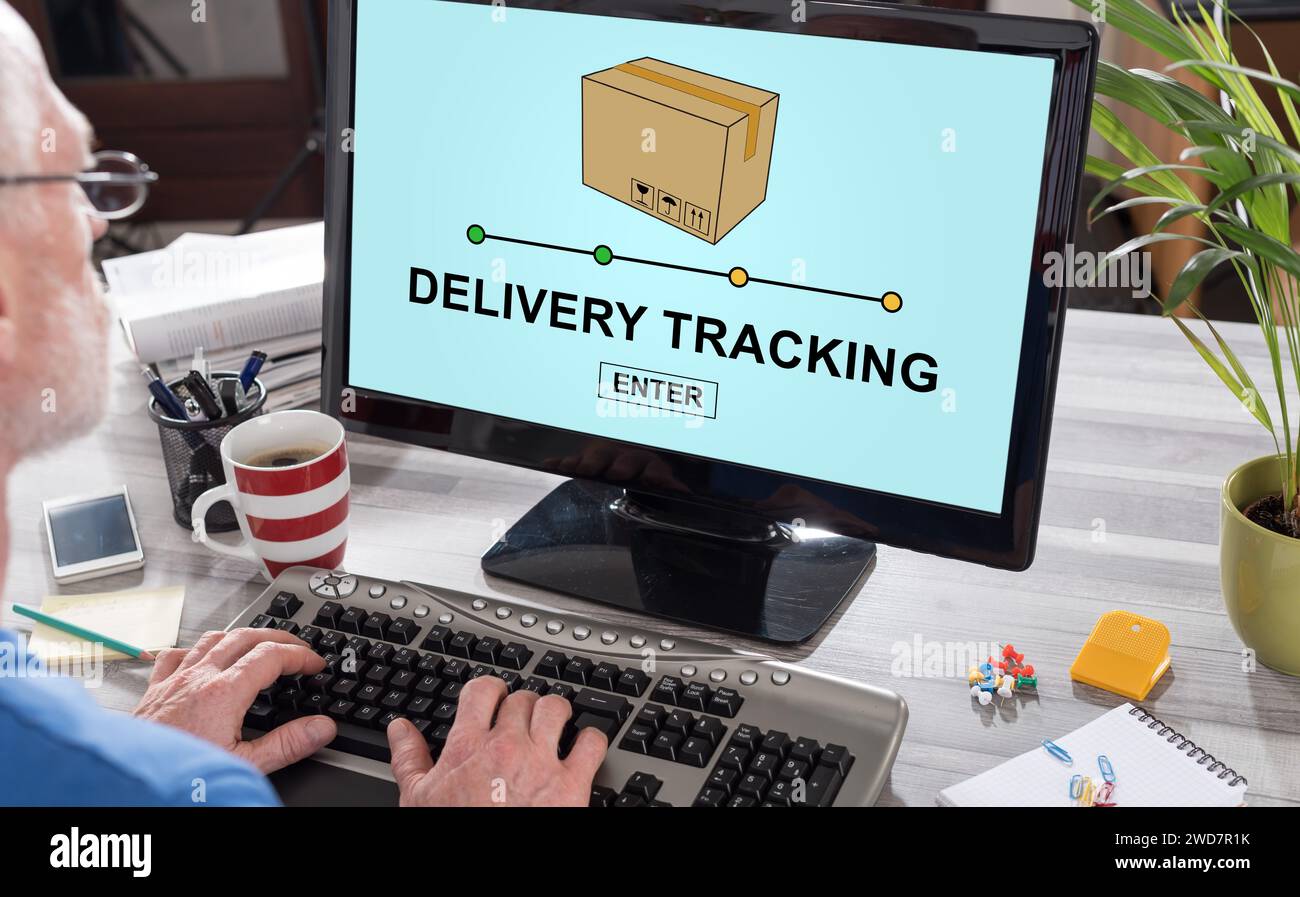Man using a computer with delivery tracking concept on the screen Stock Photo