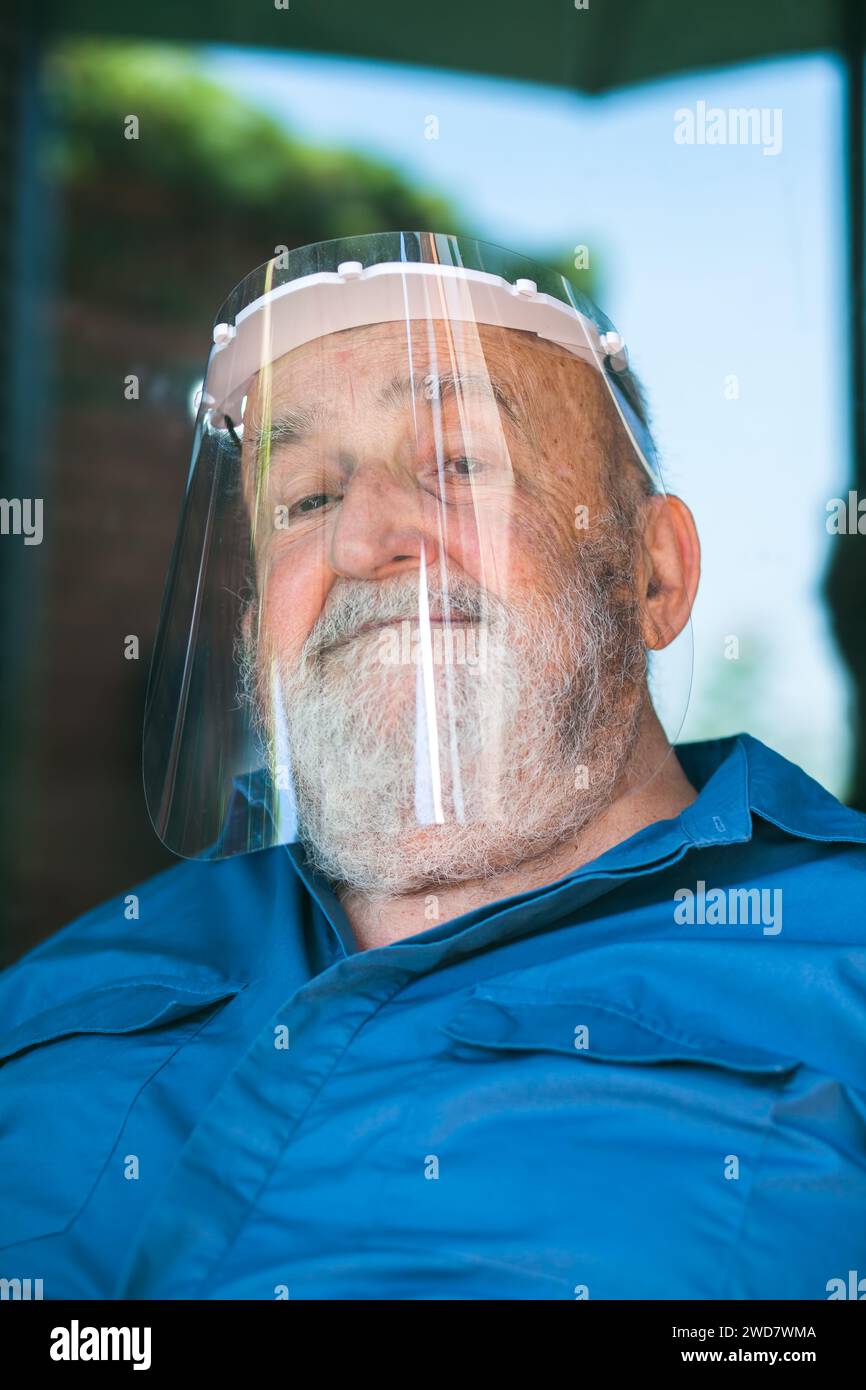 elderly man wearing a protective visor Stock Photo