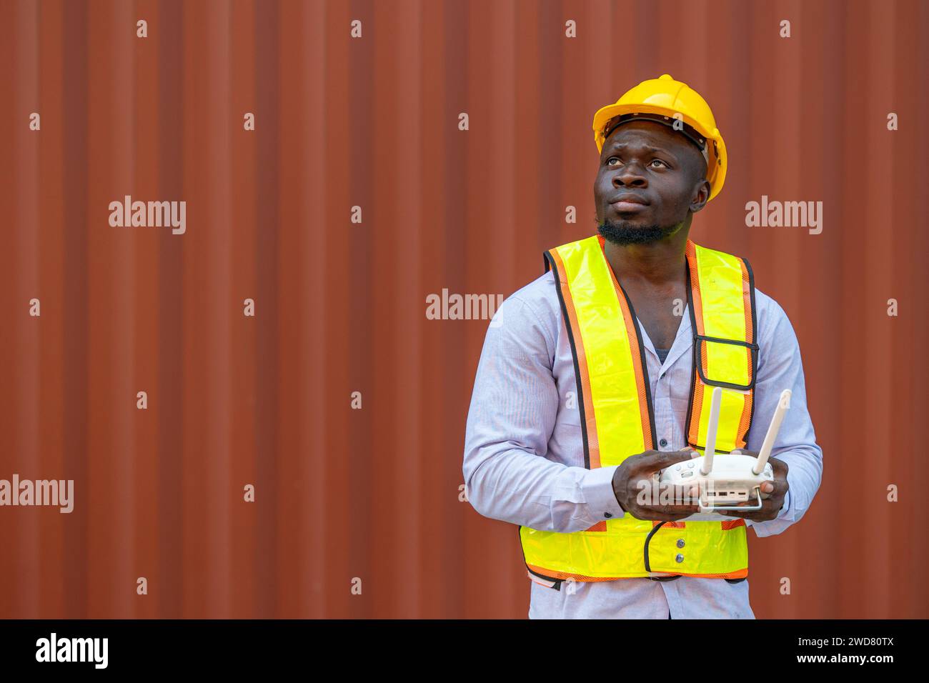 Staff worker using Drone aerial imaging system in port container yard. UAV Patrol flying guard technology for survey and security safety area in logis Stock Photo