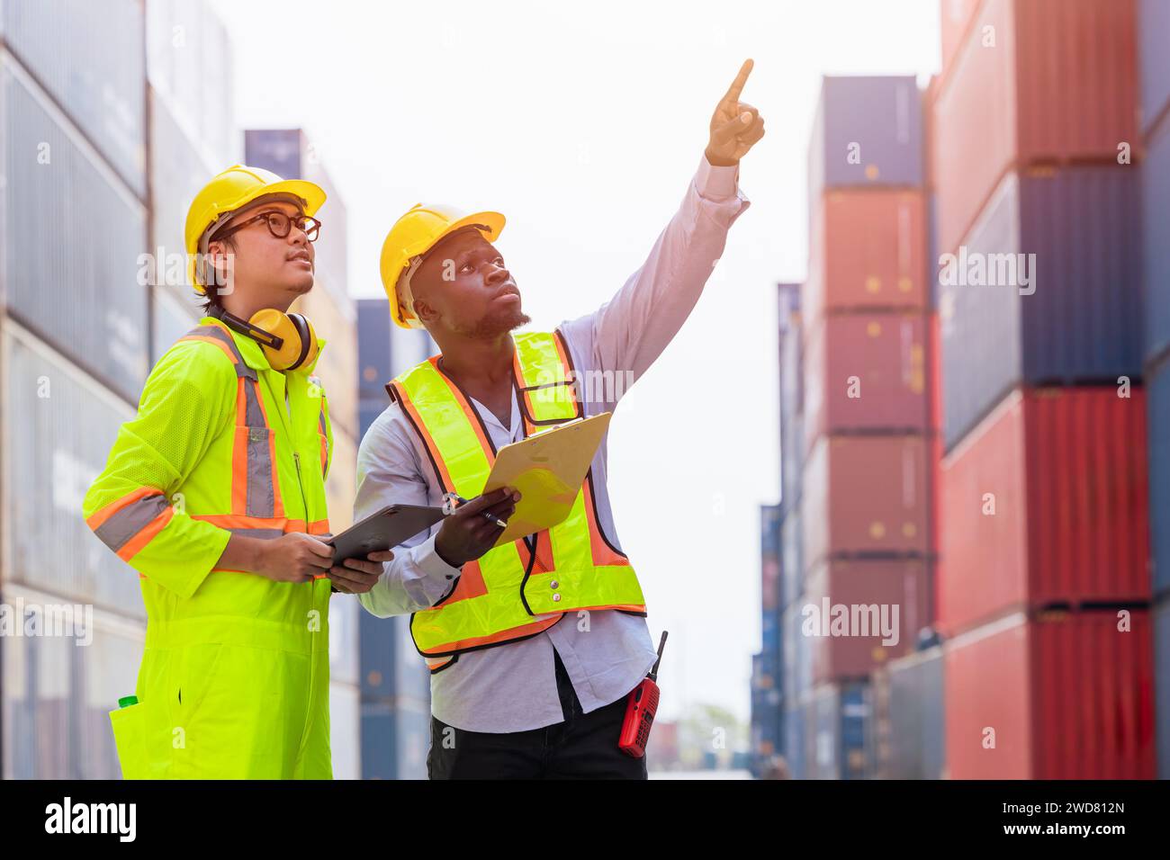diversity model staff workers in port container yard logistics cargo shipping import export management industry teamwork. Stock Photo
