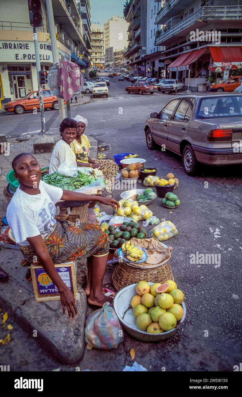 Ivory Coast, Abidjan; Female street vendors selling fruits. Stock Photo