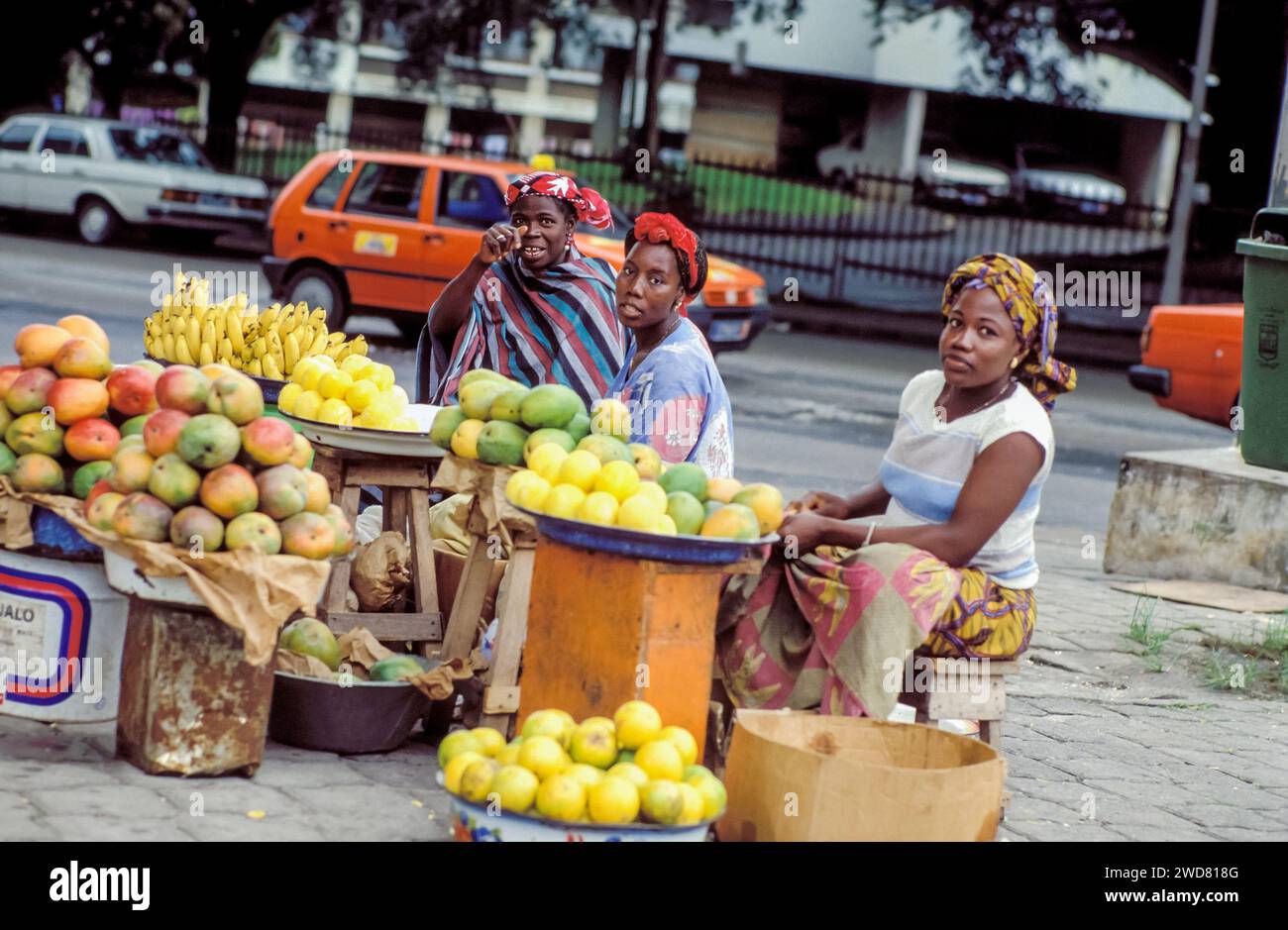 Ivory Coast, Abidjan; Female street vendors selling fruits. Stock Photo