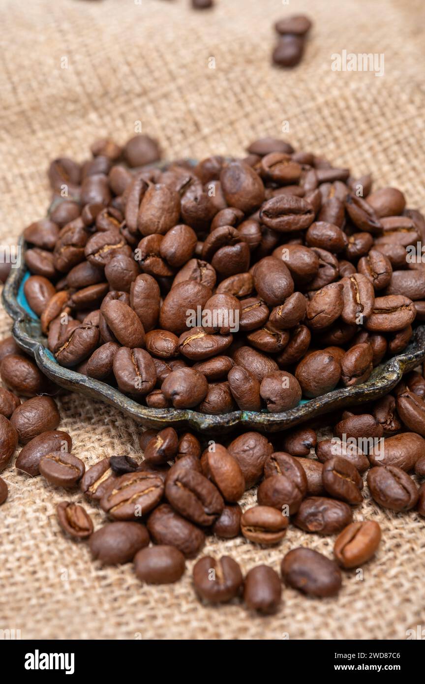 Arabica brown roasted coffee beans from Africa coffee producing region, cultivating in Ethiopia, Ivory Coast, Uganda, Kenya, Rwanda and Tanzania, clos Stock Photo