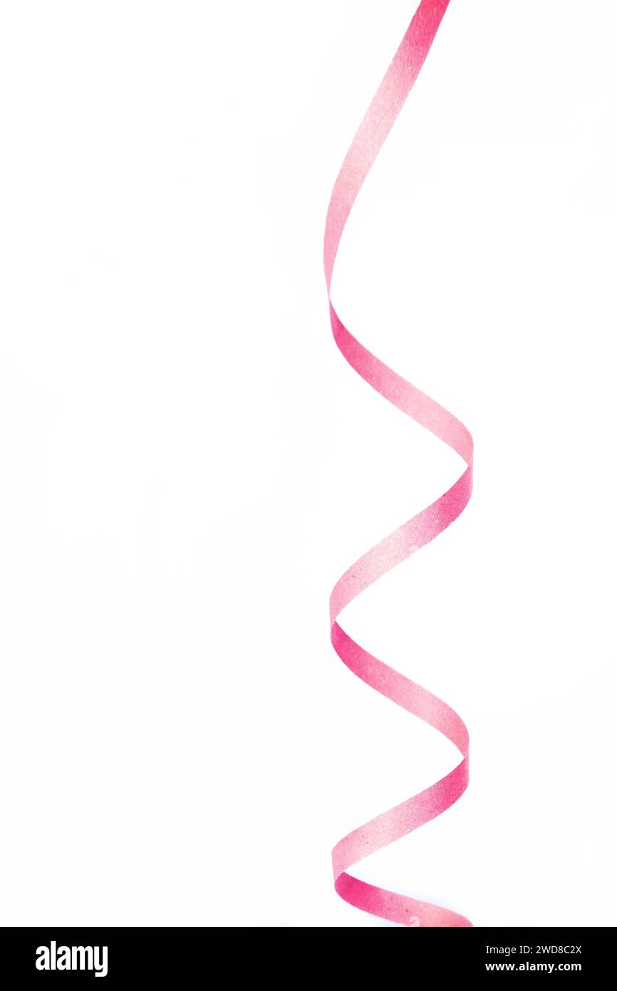 Minimalist image of a pink helical shaped ribbon isolated on white background. Copy space Stock Photo