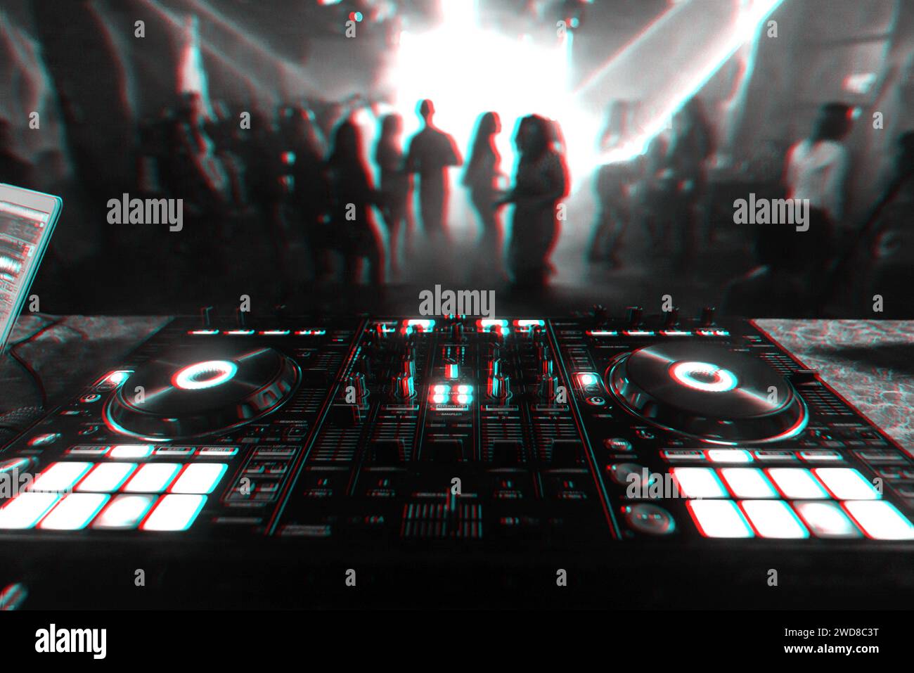 professional DJ mixer controller for mixing music in a nightclub with dancing people on the dance floor in the background. Black and white photo with Stock Photo