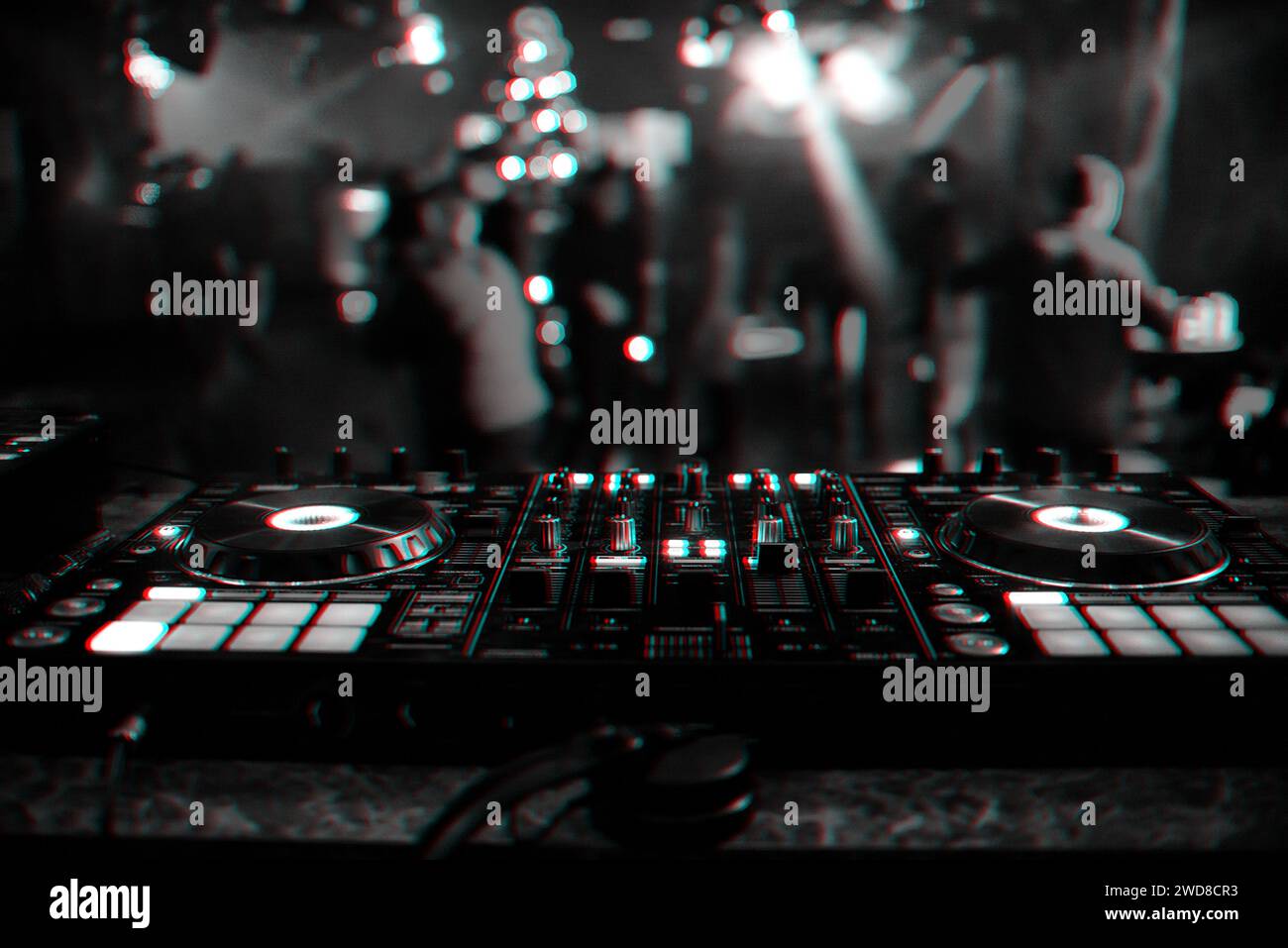 DJ mixer controller Board for mixing music in a nightclub at a party. Black and white photo with glitch effect and small grain Stock Photo