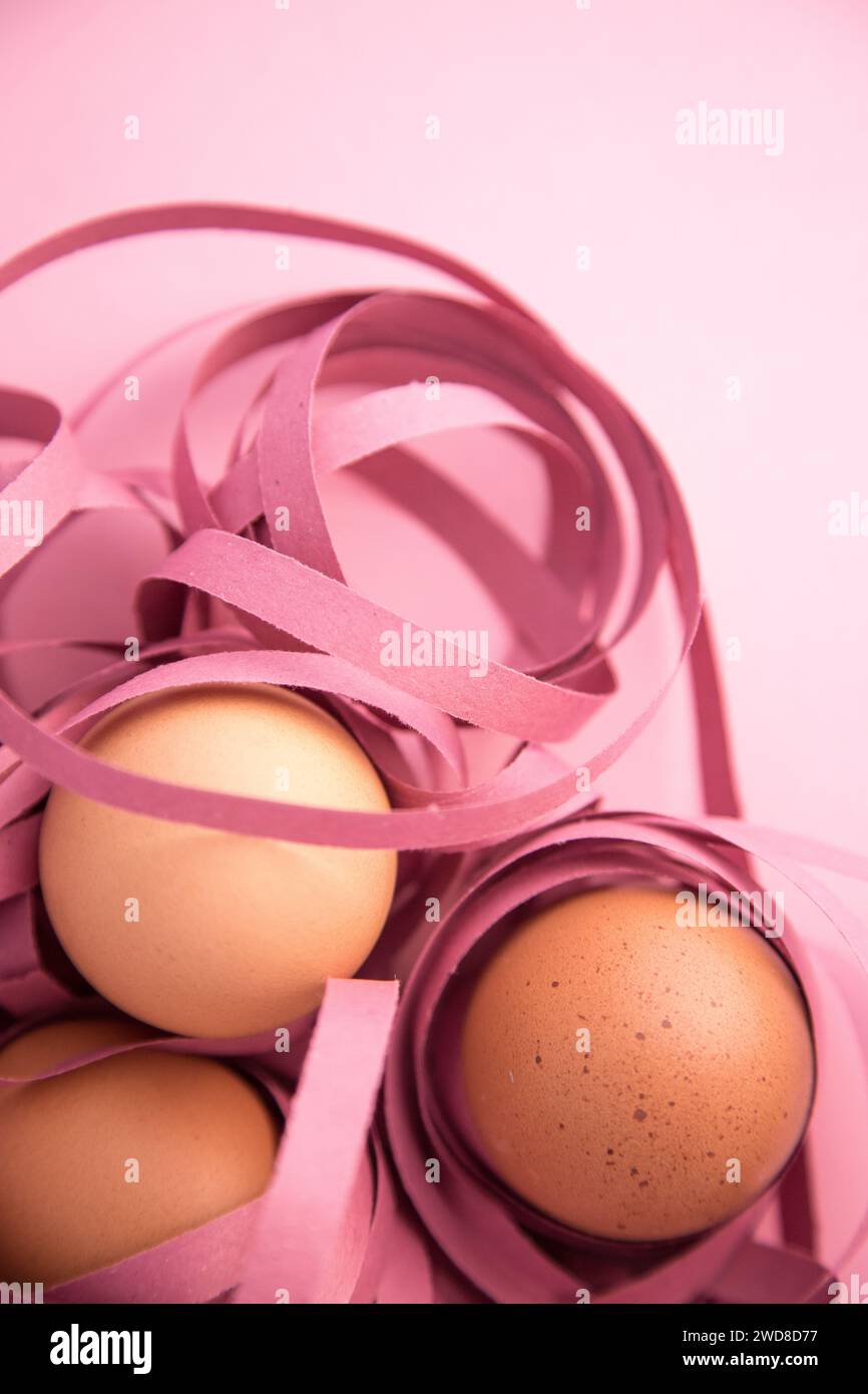 Happy Easter. Closeup of three eggs wrapped in colored ribbons. Fragility and protection concept. Stock Photo
