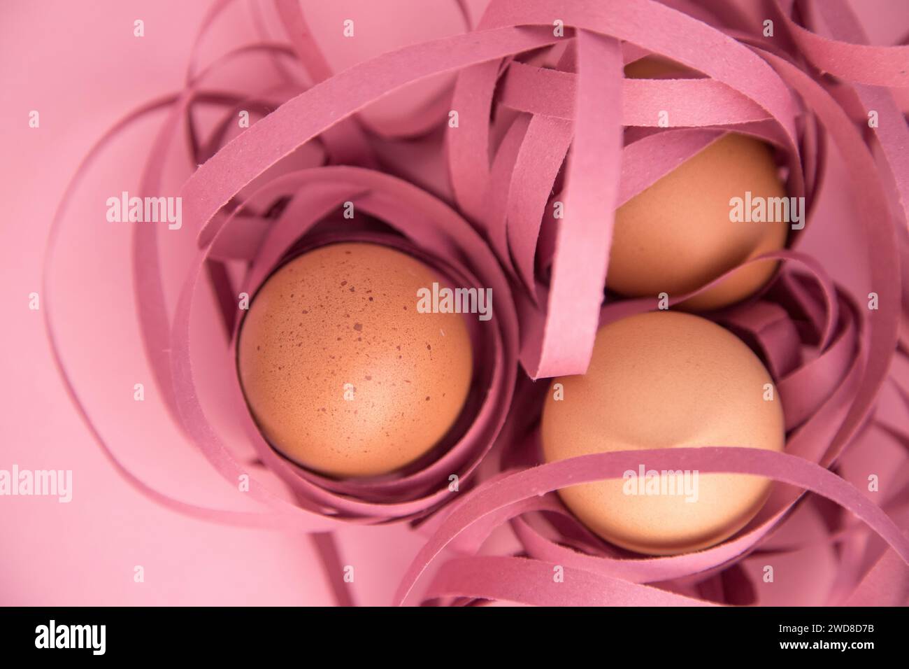 Happy Easter. Closeup of three eggs wrapped in colored ribbons. Fragility and protection concept. Stock Photo