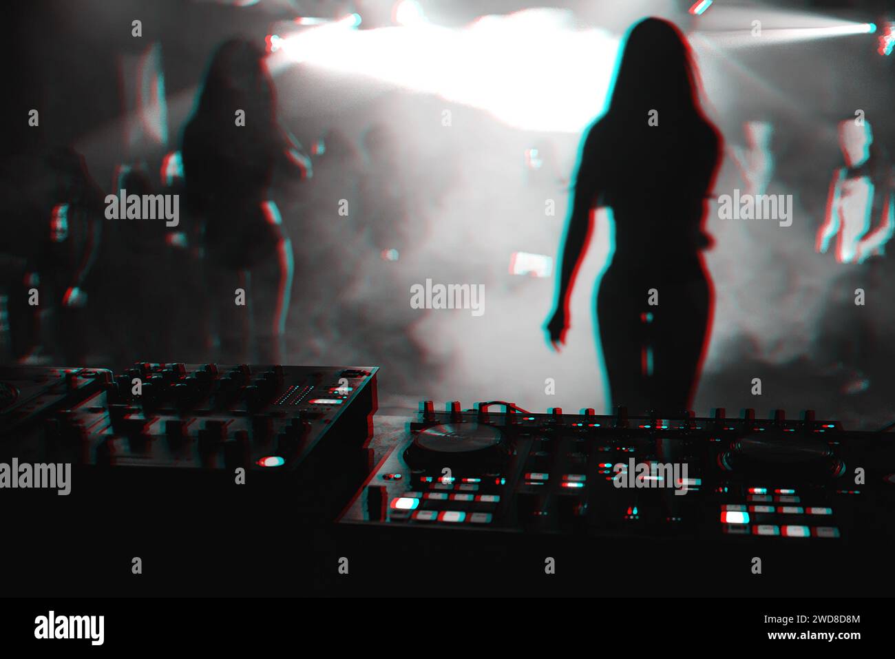 silhouette girls dancers on stage in a nightclub on the background music the mixer DJ. Black and white photo with glitch effect and small grain Stock Photo