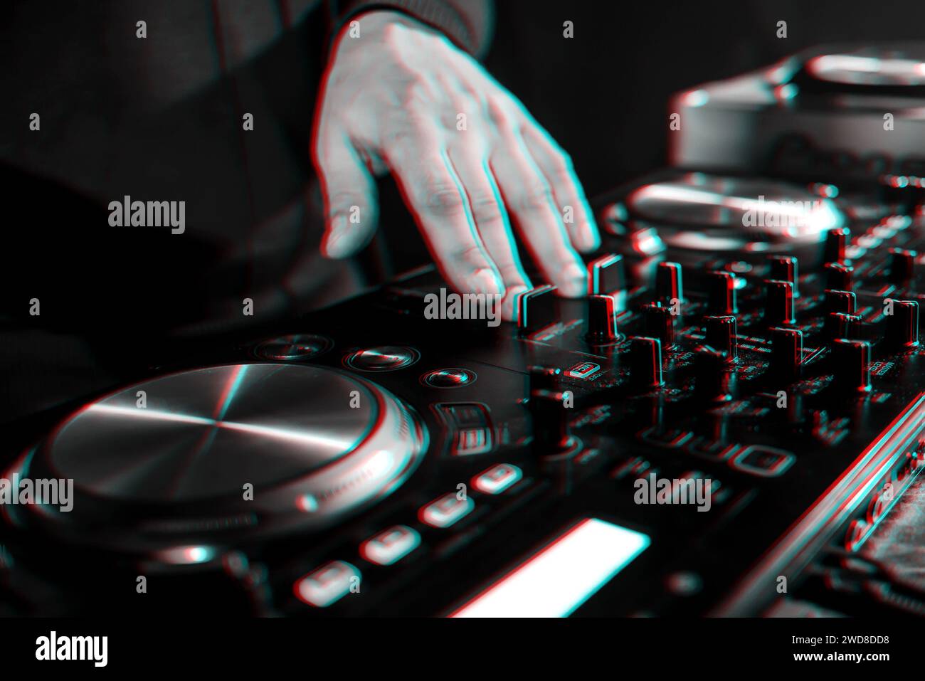hand moving of the DJ controllers on the music control panel in night