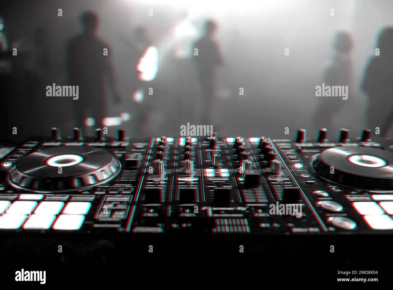DJ mixer on the table background the night club and dancing people. Black and white photo with glitch effect and small grain Stock Photo