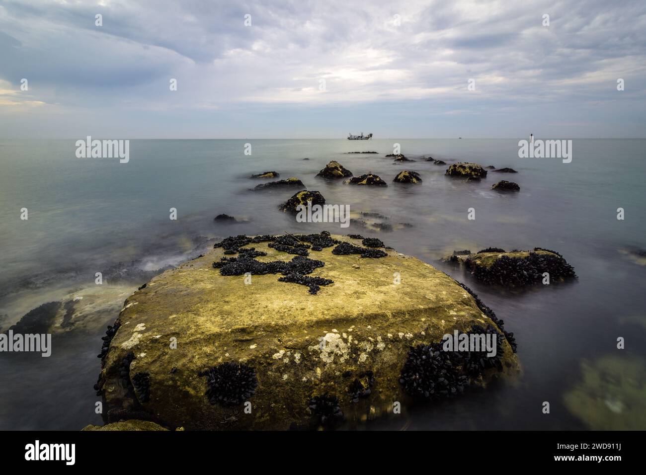 A quiet lake on the Mediterranean with stones in the water Stock Photo