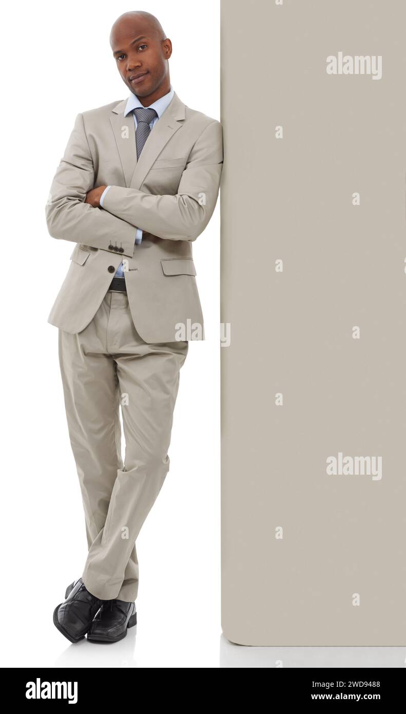 Businessman, portrait and leaning on wall in confidence with arms crossed on a white studio background. Young black man, African employee or Stock Photo