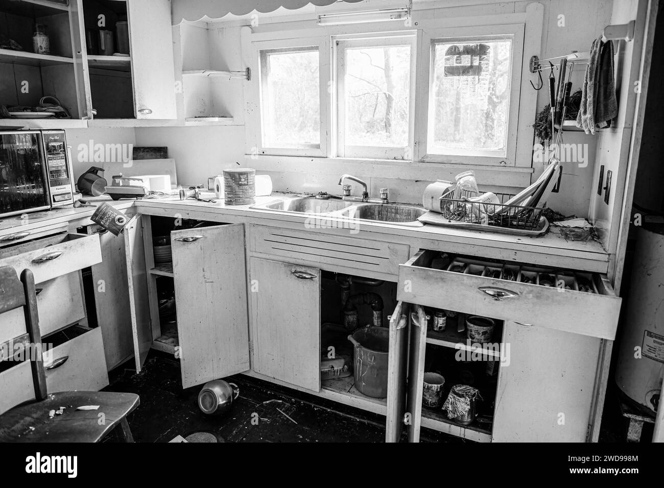 Black and white photograph of a kitchen scene Stock Photo