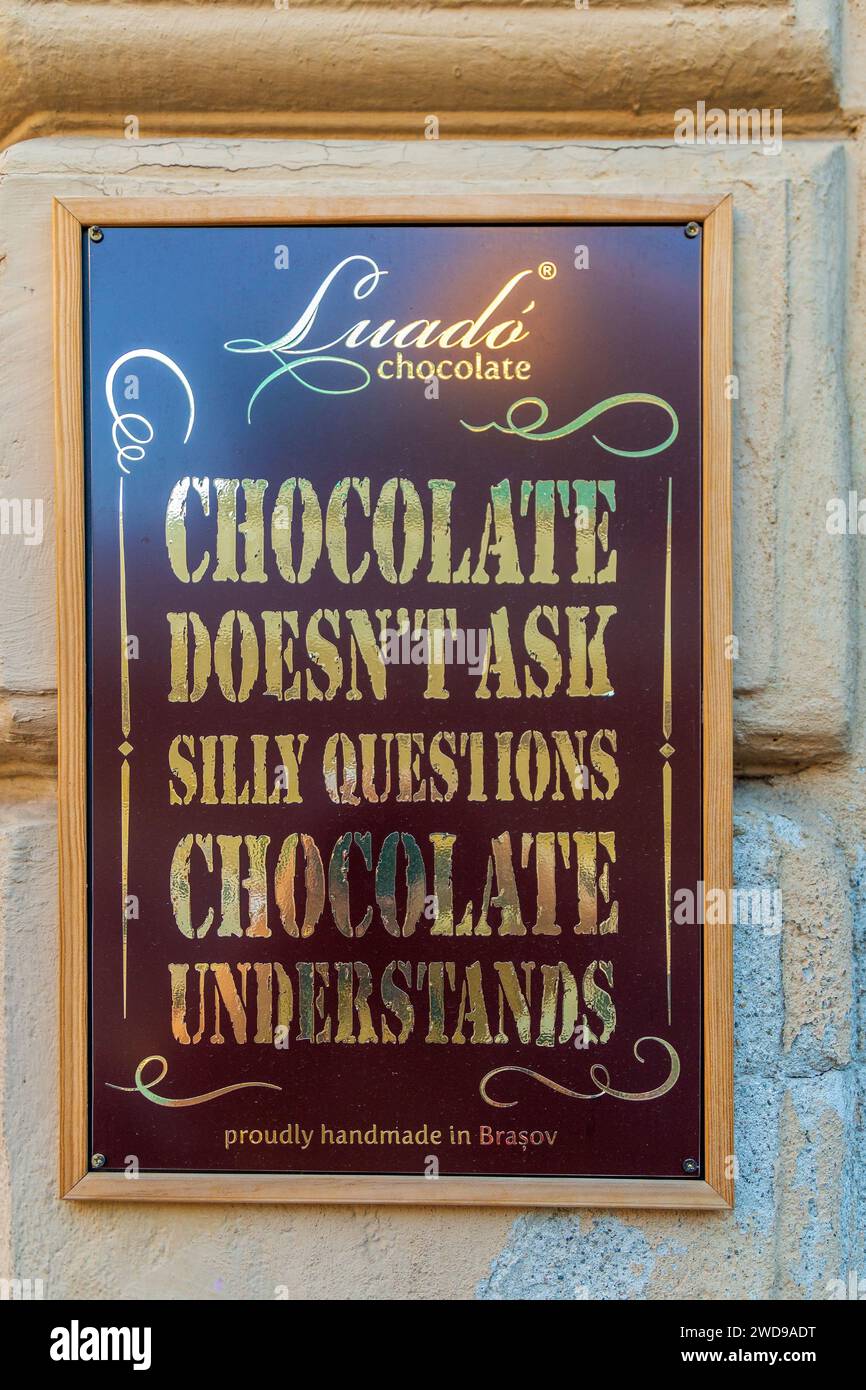 BRASOV, TRANSYLVANIA, ROMANIA - JULY 11, 2020: Funny inscription on the facade of a confectionery specialized in making chocolate. Stock Photo