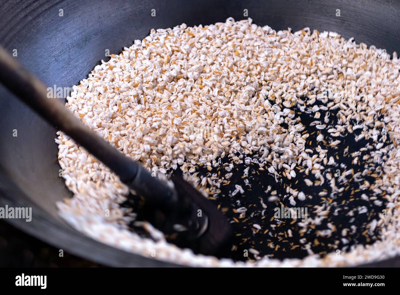 Popcorn rice or pop rice made using black sand instead of oil in