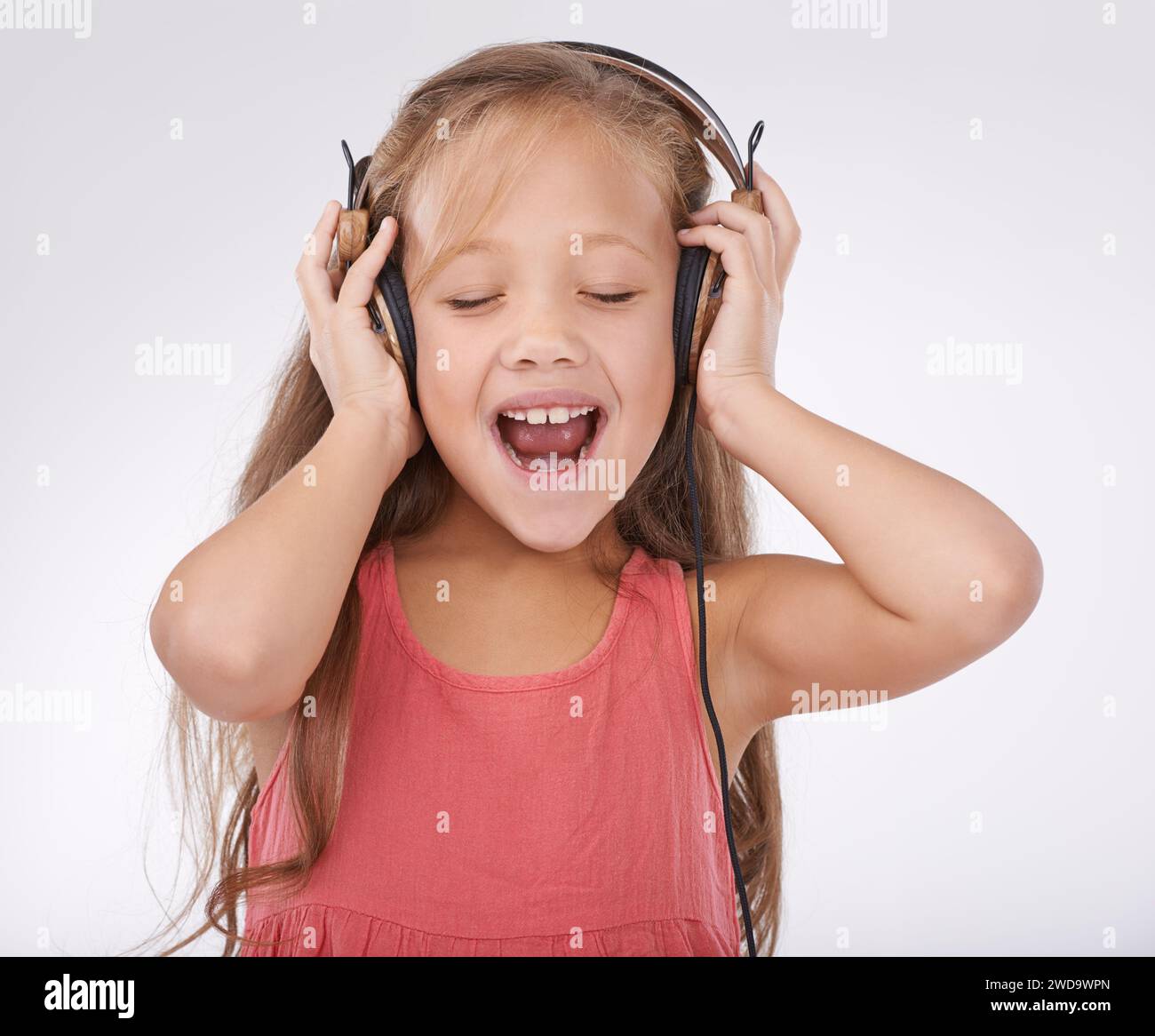 Girl kid, music and singing with headphones in studio for audio ...