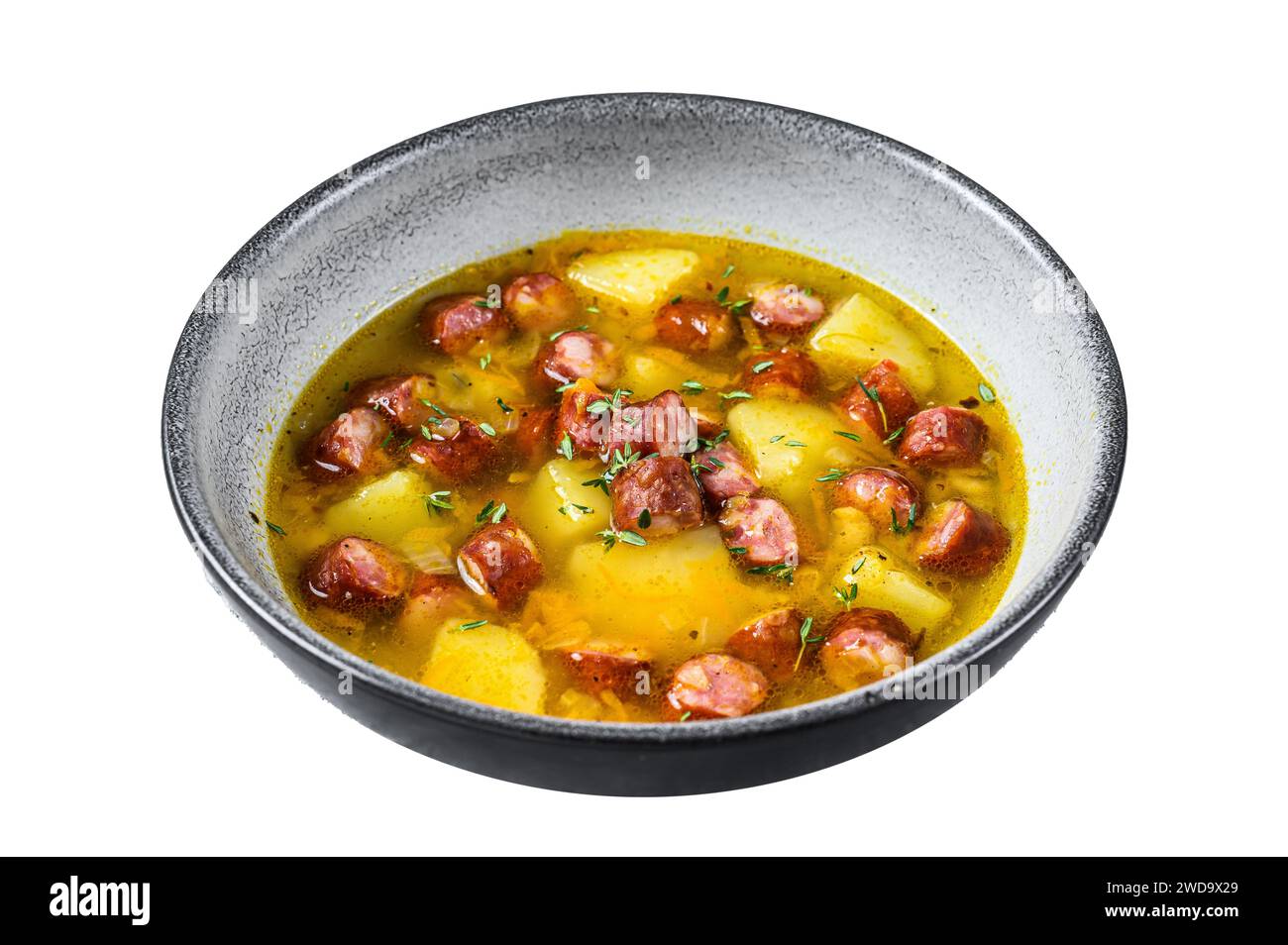 German Split pea soup with smoked sausages. Isolated on white