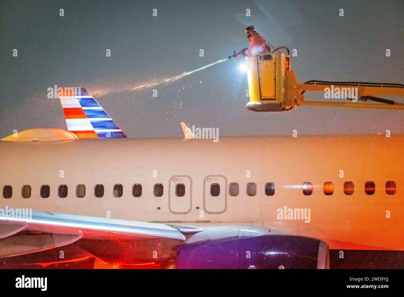 Columbus, Ohio, USA. 19th Jan, 2024. Delta Airlines de-icing crews spray down a plane on the tarmac of the John Glenn Columbus International Airport early Friday morning January 19, 2024. Winter weather moved thru the Midwest snarling traffic with cancelations and delays. (Credit Image: © James D. DeCamp/ZUMA Press Wire) EDITORIAL USAGE ONLY! Not for Commercial USAGE! Credit: ZUMA Press, Inc./Alamy Live News Stock Photo