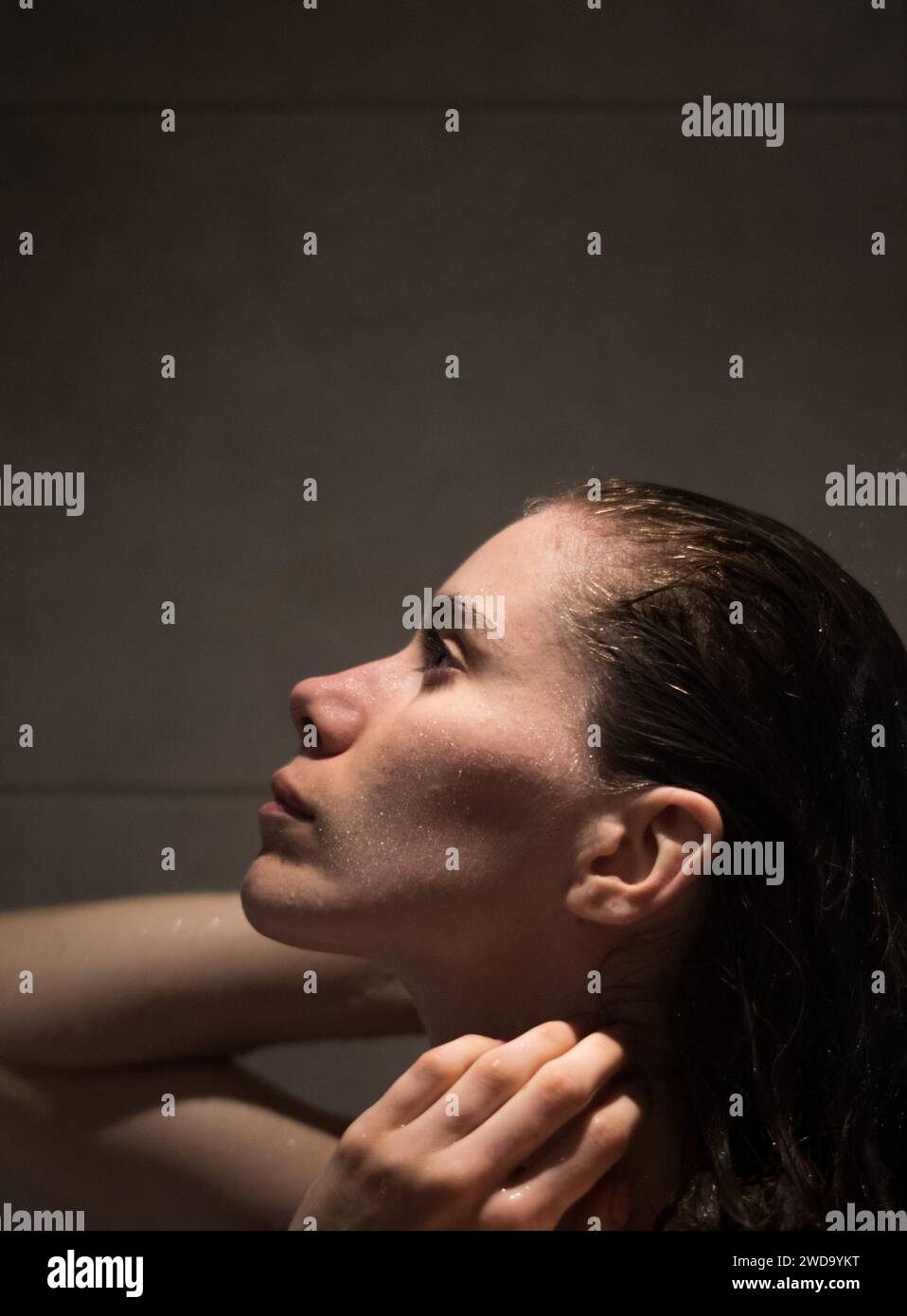 A young White woman taking a shower Stock Photo