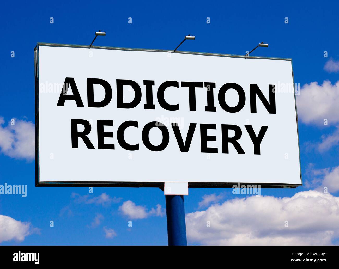Addiction recovery symbol. Concept words Addiction recovery on beautiful white billboard. Beautiful blue sky white cloud background. Psychology addict Stock Photo