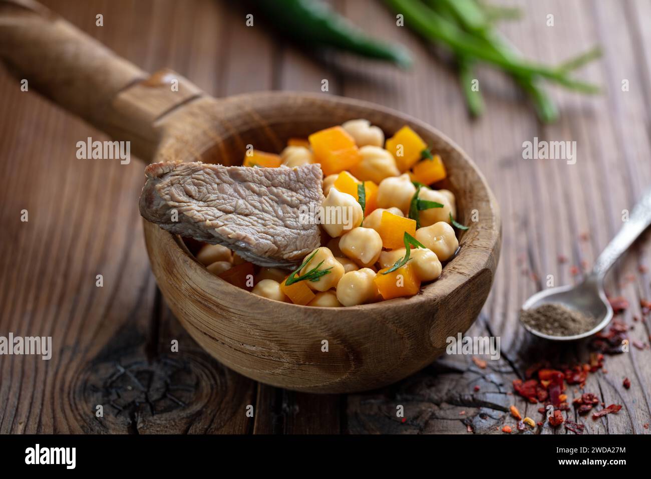 Central Asian food Nohatshurak soup with peas, vegetables and spices. Uzbek and Central Asia cuisine concept. Side view Stock Photo