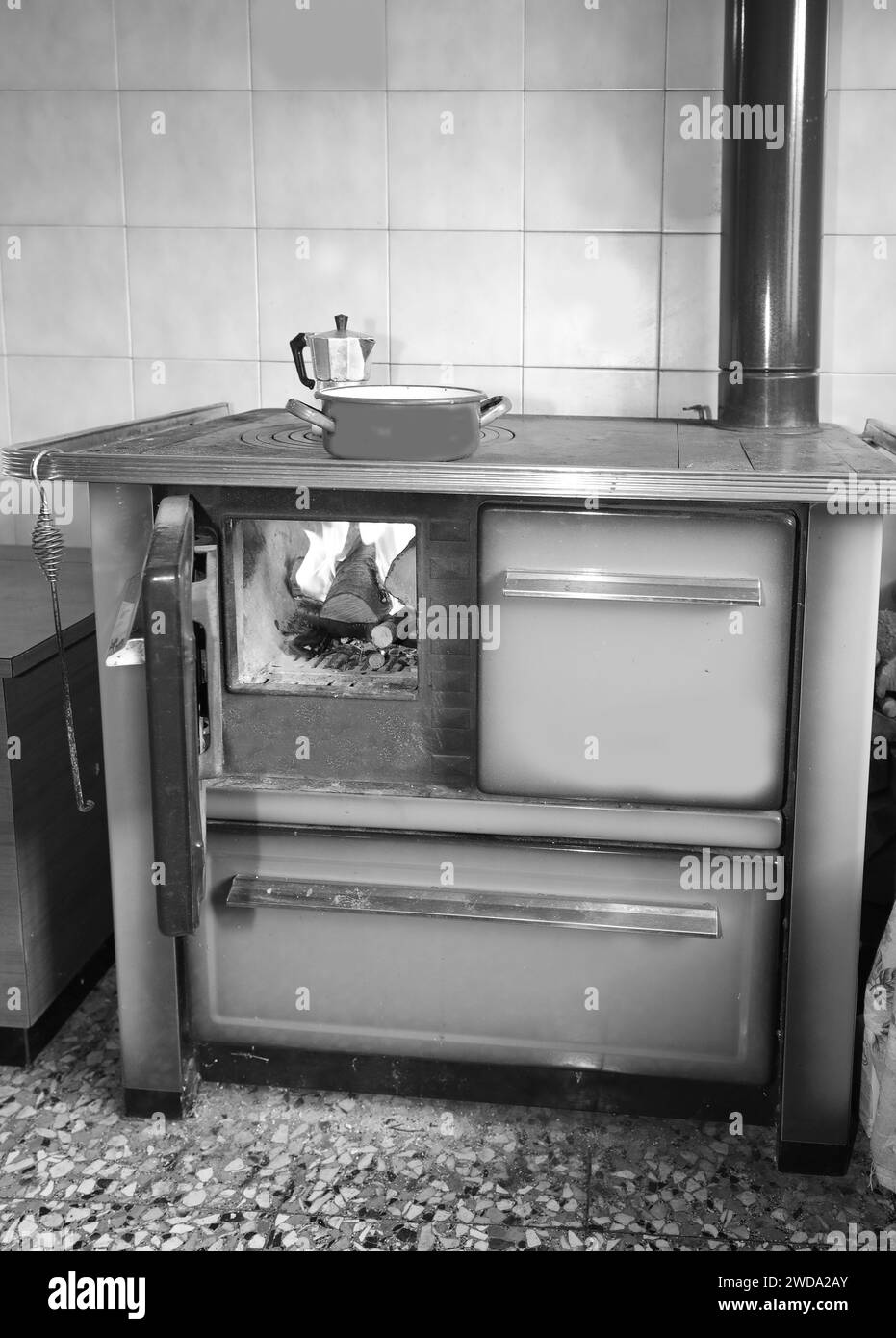 old wood stove of a cheap kitchen with moka to making good coffee with antique white and black effect Stock Photo