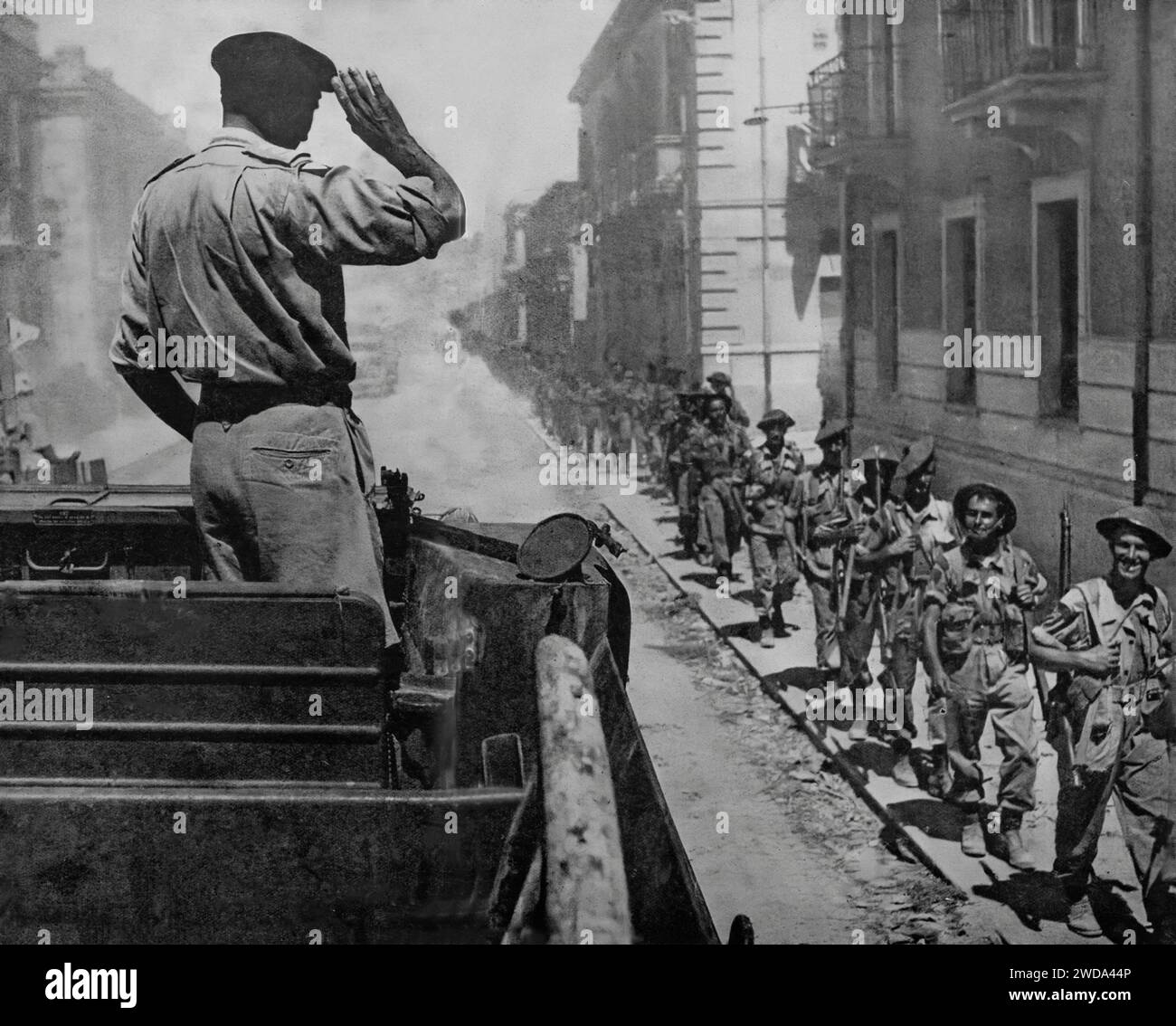 Field Marshal Bernard Law Montgomery saluting troops from a bren gun carrier  in Reggio during the Allied invasion of Italy in the Second World War: 3rd September 1943. Stock Photo