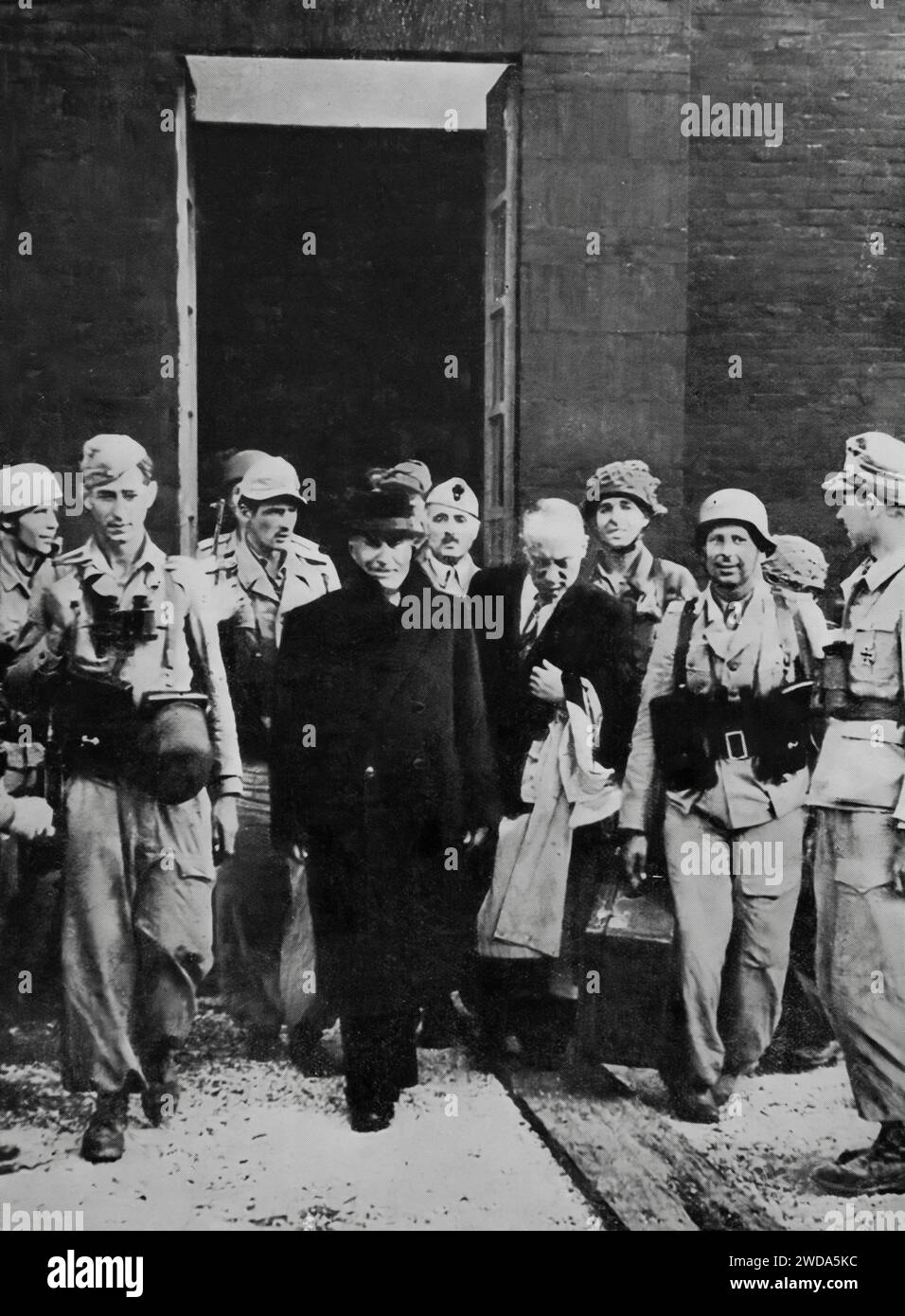 Overthrown in July 1943, the Italian dictator Mussolini was imprisoned in the Gran Sassa Hotel in the Abruzzo Mountains He can be seen walking from captivity on the 12th September German troops released him during the Second World War. Stock Photo