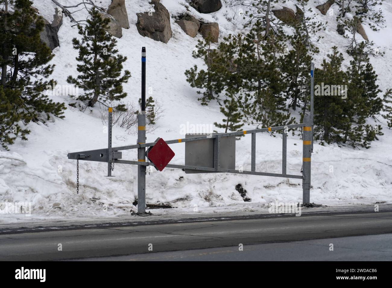 Mountain pass road gate in Sierra Nevada mountains that closes during severe winter storms and for avalanche control. Stock Photo