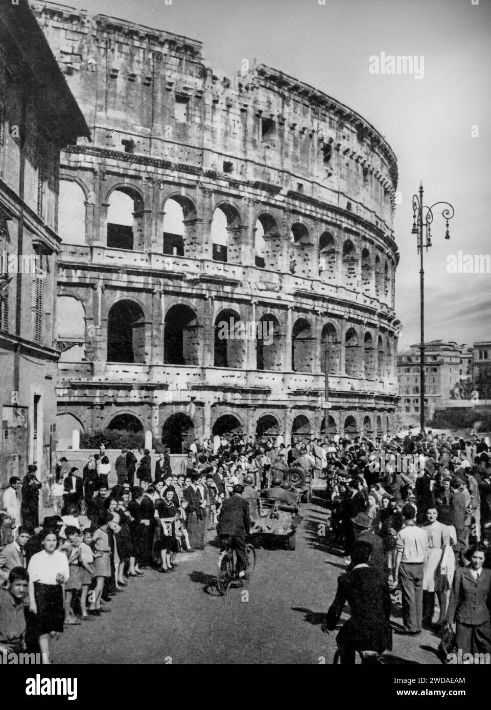 On the morning of 4th June 1944, American troops pass the Colliseum in Rome to the delight of the civilians. Followed by Allied tanks, by evening the city had been liberated. Stock Photo
