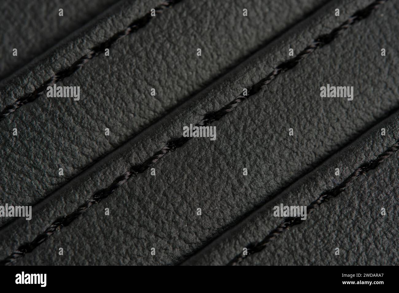 Background is made black leather stitched with black threads Stock Photo