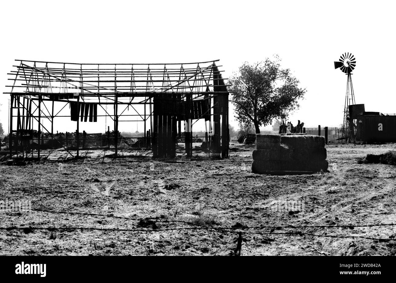 The remnants of an old cattle farm with a barn and windmill in San Bernardino, California Stock Photo