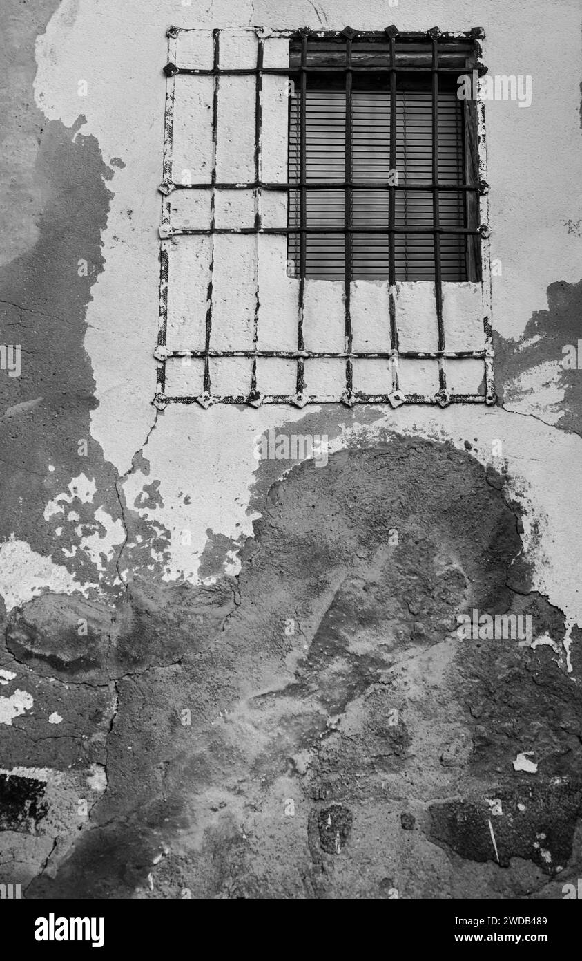 Window with iron grill on chipped facade Stock Photo Alamy