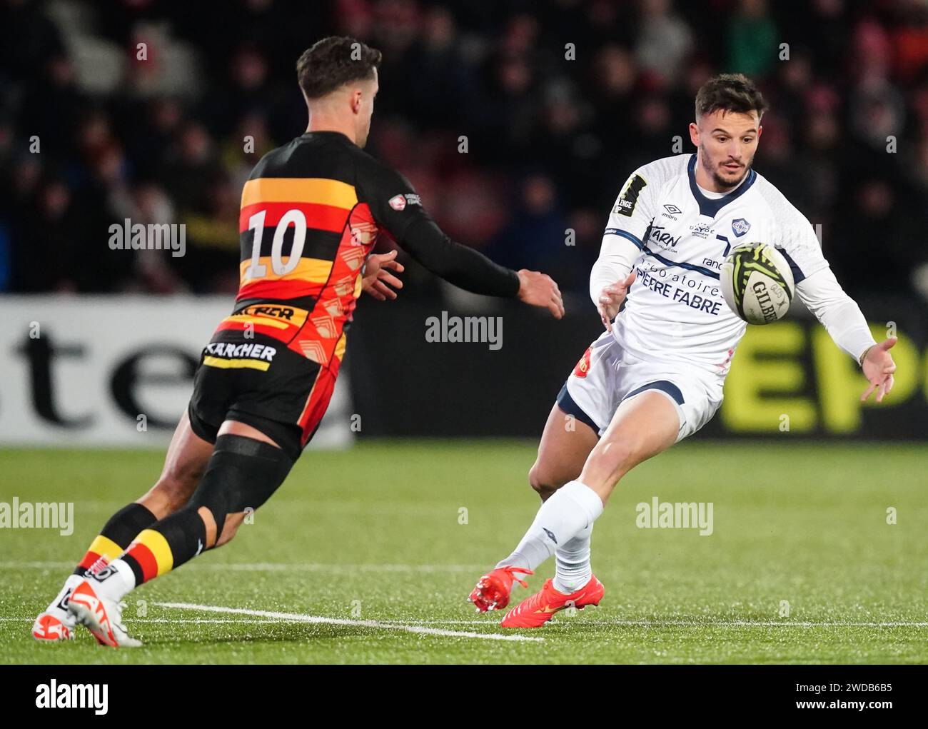 Castres Olympique's Pierre Popelin (right) offloads the ball during the