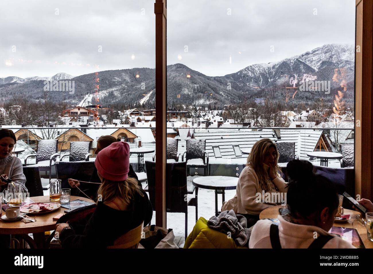 Zakopane, Poland, January 19, 2024. Families sit in a rooftop cafe with a view of the mountain