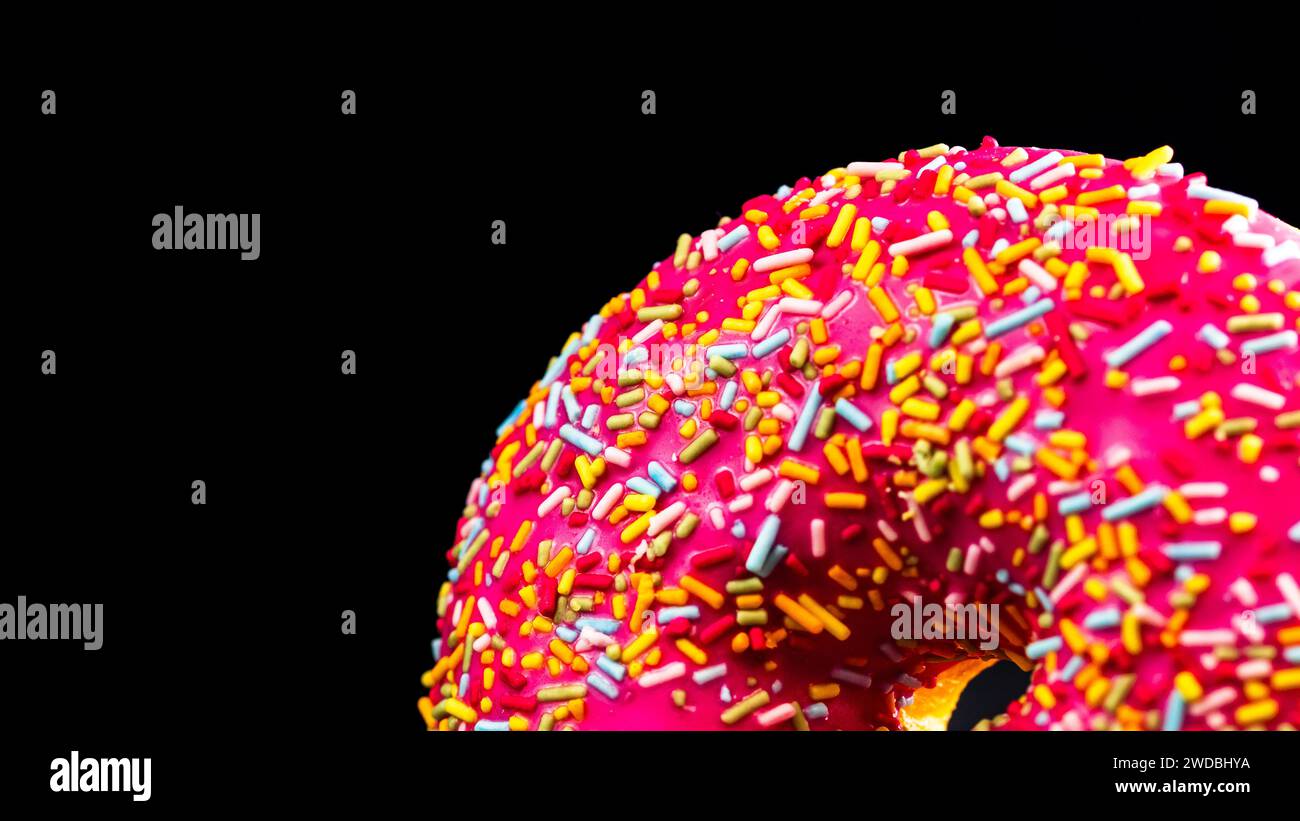 Pink glazed donut with sprinkles isolated. Close up of colorful donut ...