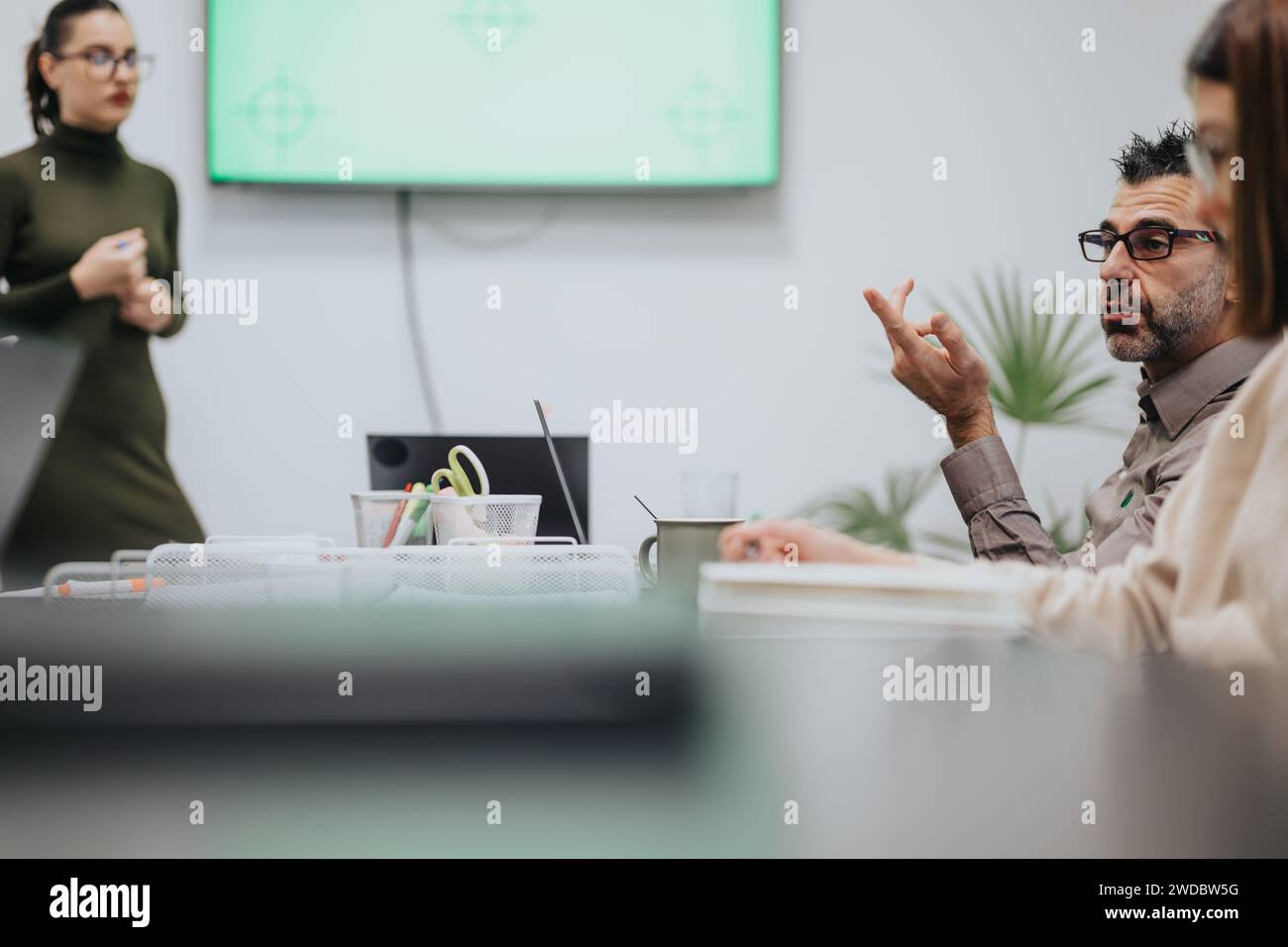 Business team collaborating in late evening meeting. Stock Photo