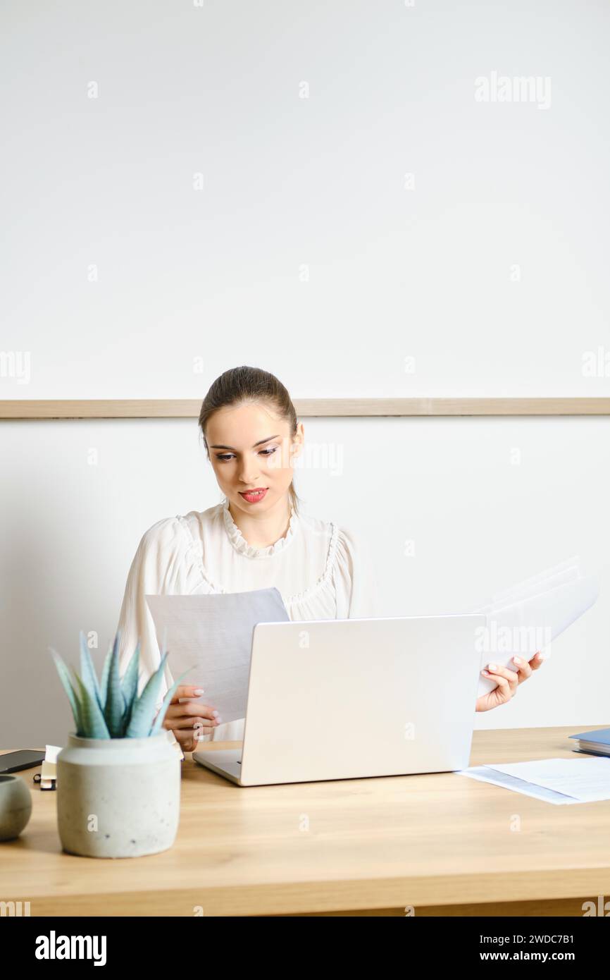 Woman working with papers in modern office Stock Photo