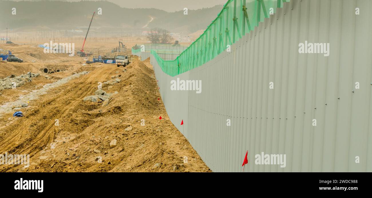 Perspective view of gray metal barrier wall at new construction site ...