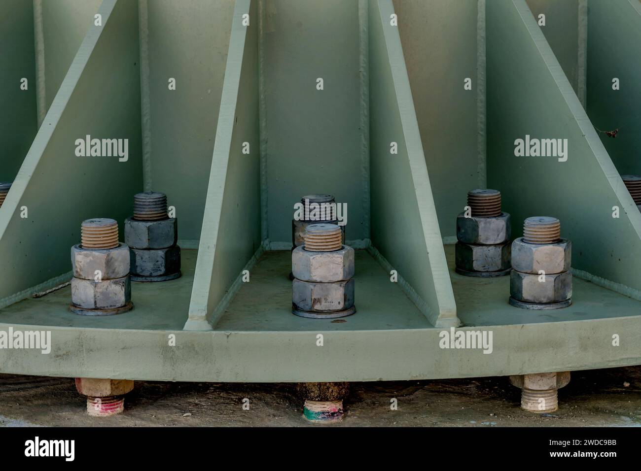 Large nuts and bolts holding steel platform to foundation, South Korea