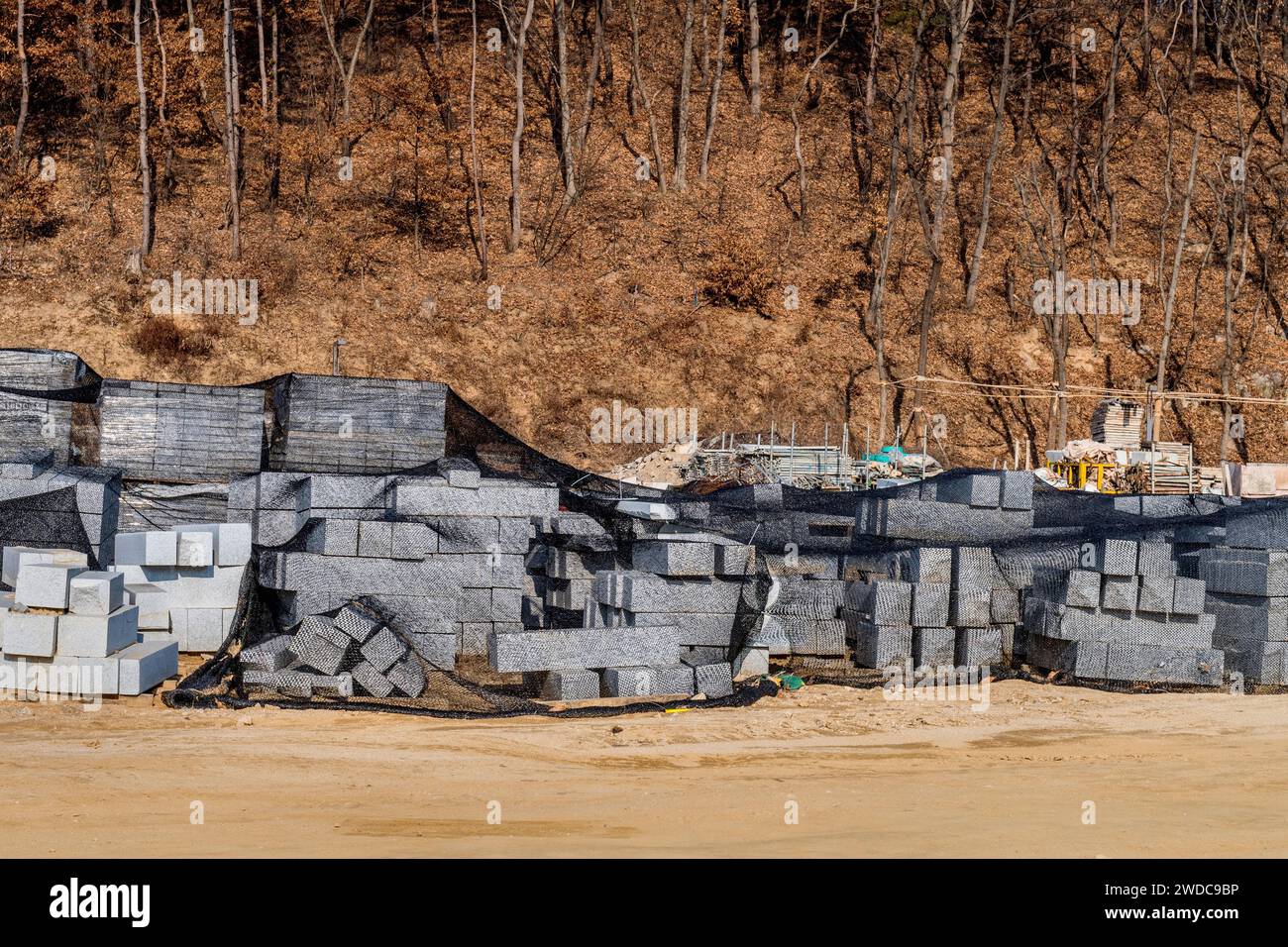 Stacks of concrete blocks covered with black mesh at new construction
