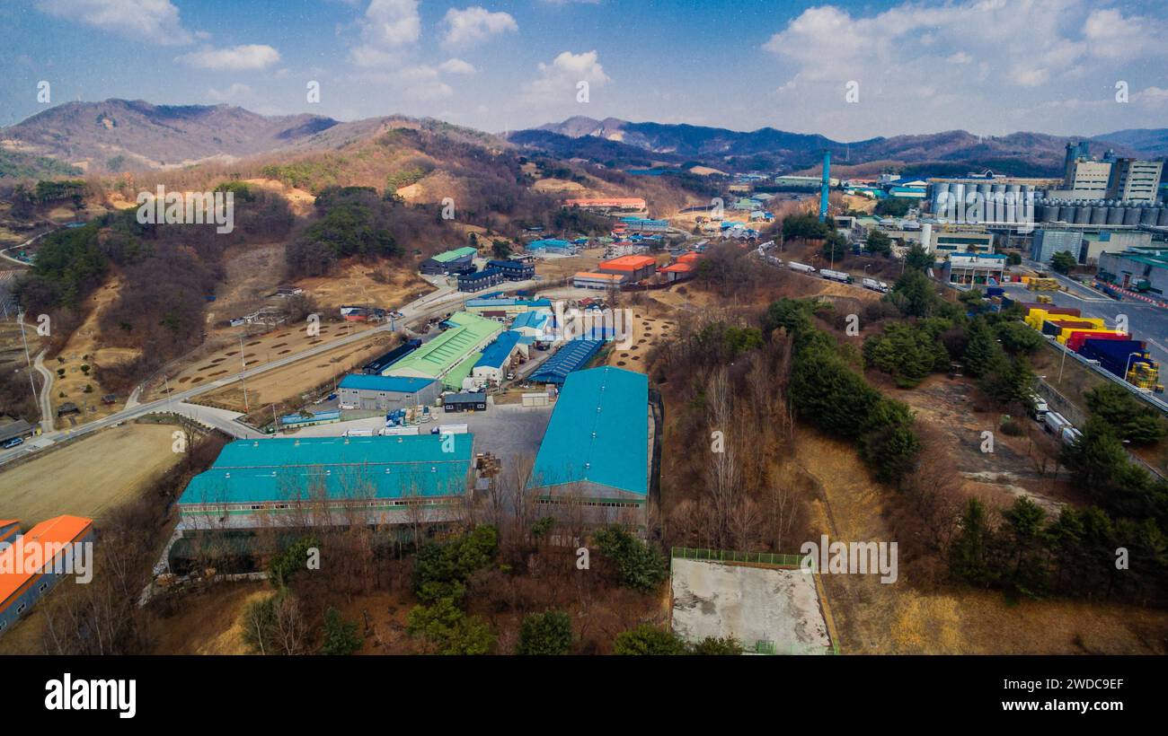 Aerial view of buildings and cars in small rural industrial park under cloudy skies, South Korea, South Korea Stock Photo