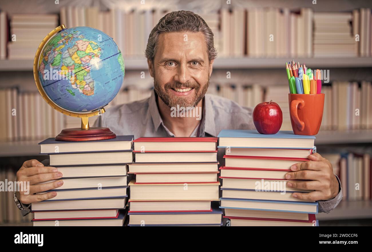 university teacher professor in school classroom library preparing for ...
