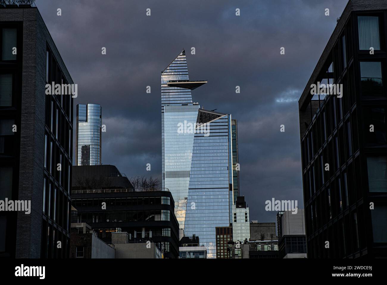 Cityscape with dramatic sky, view looking north from Chelsea neighborhood to 10 Hudson Yards and 30 Hudson Yards, New York City, New York, USA Stock Photo