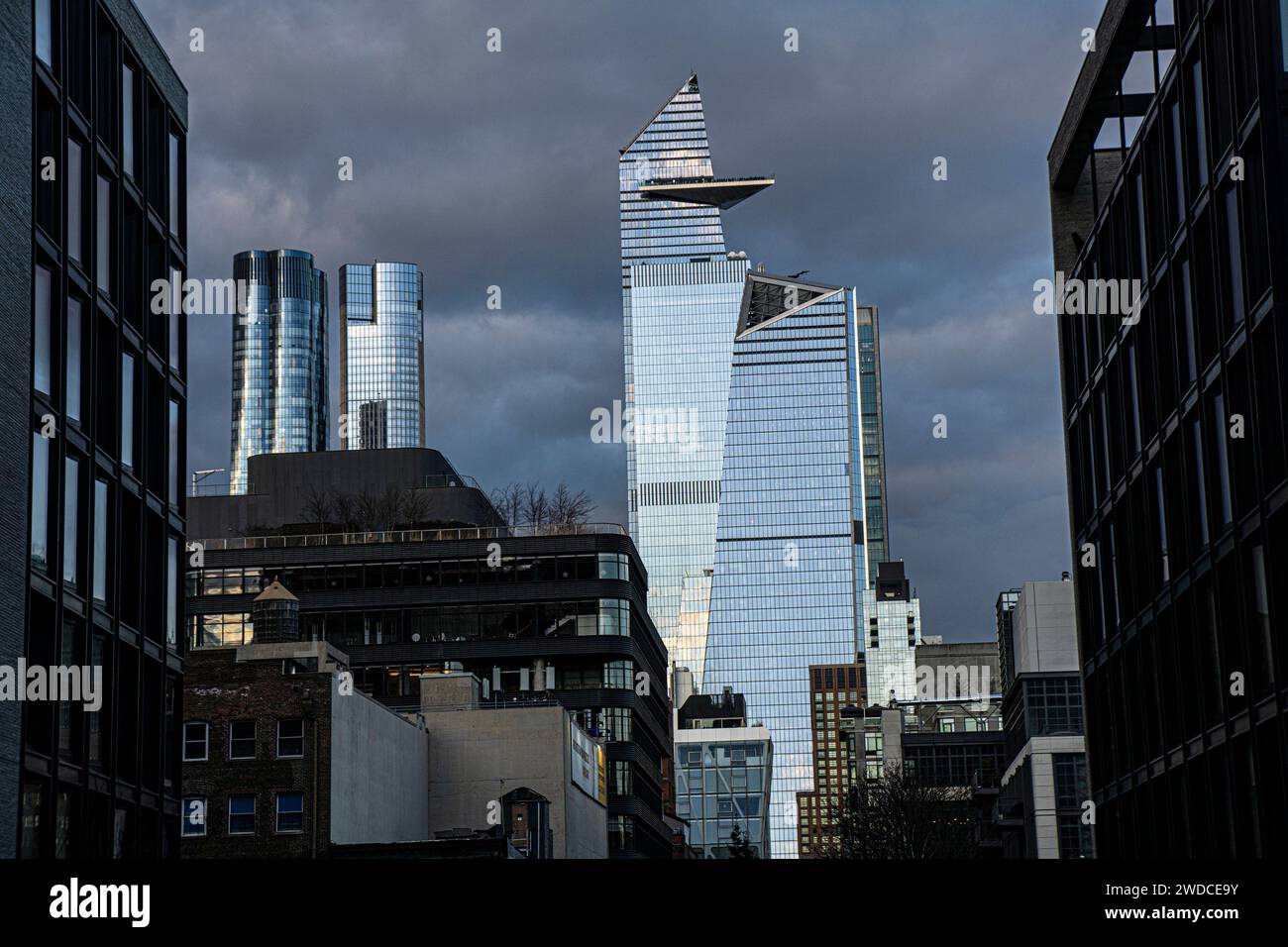 Cityscape with dramatic sky, view looking north from Chelsea neighborhood to 10 Hudson Yards and 30 Hudson Yards, New York City, New York, USA Stock Photo