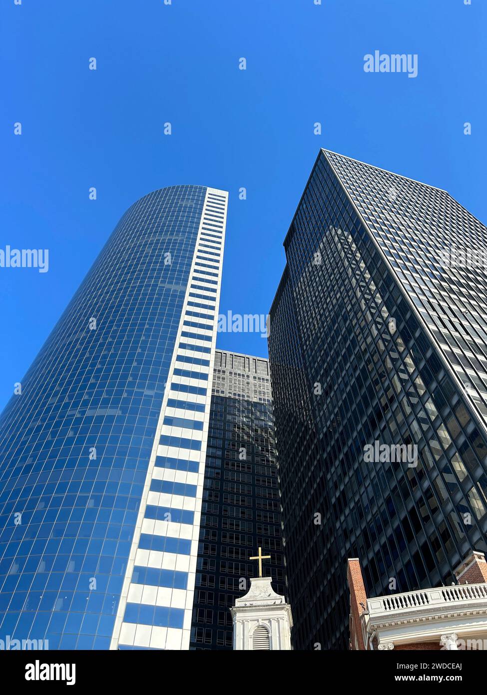 Low angle view of two modern skyscrapers rising above Church of Our Lady of the Holy Rosary, Shrine of St. Elizabeth Ann Bayley Seton, Financial District, New York City, New York, USA Stock Photo