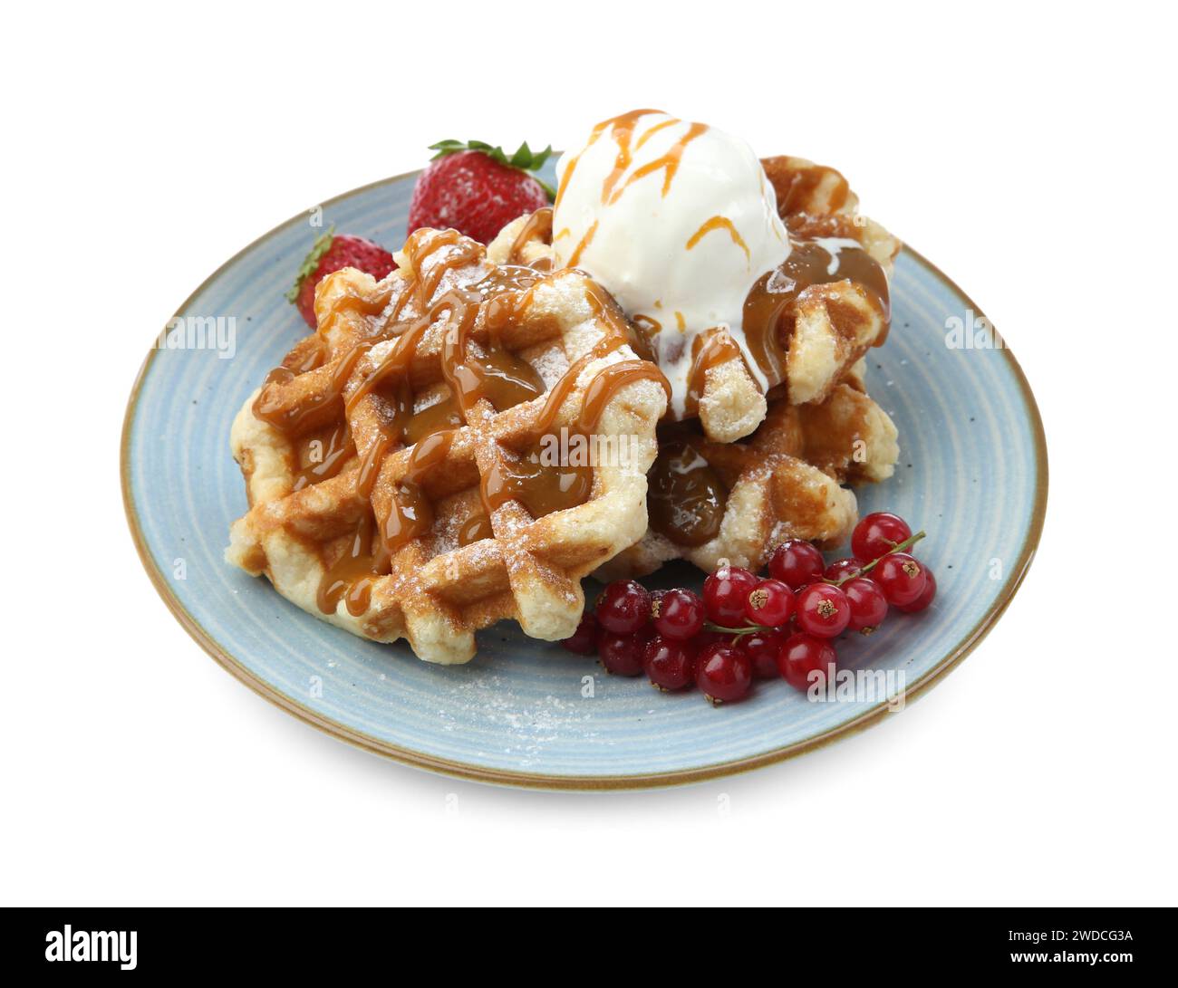 Tasty Belgian waffles with ice cream, berries and caramel syrup on ...