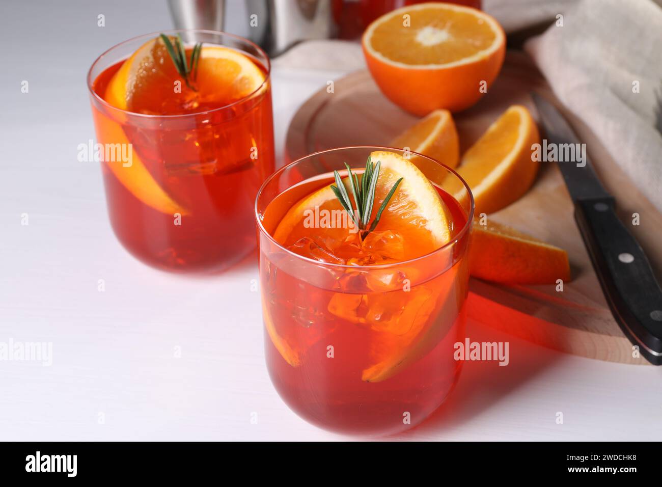 Aperol spritz cocktail, rosemary and orange slices on white table ...