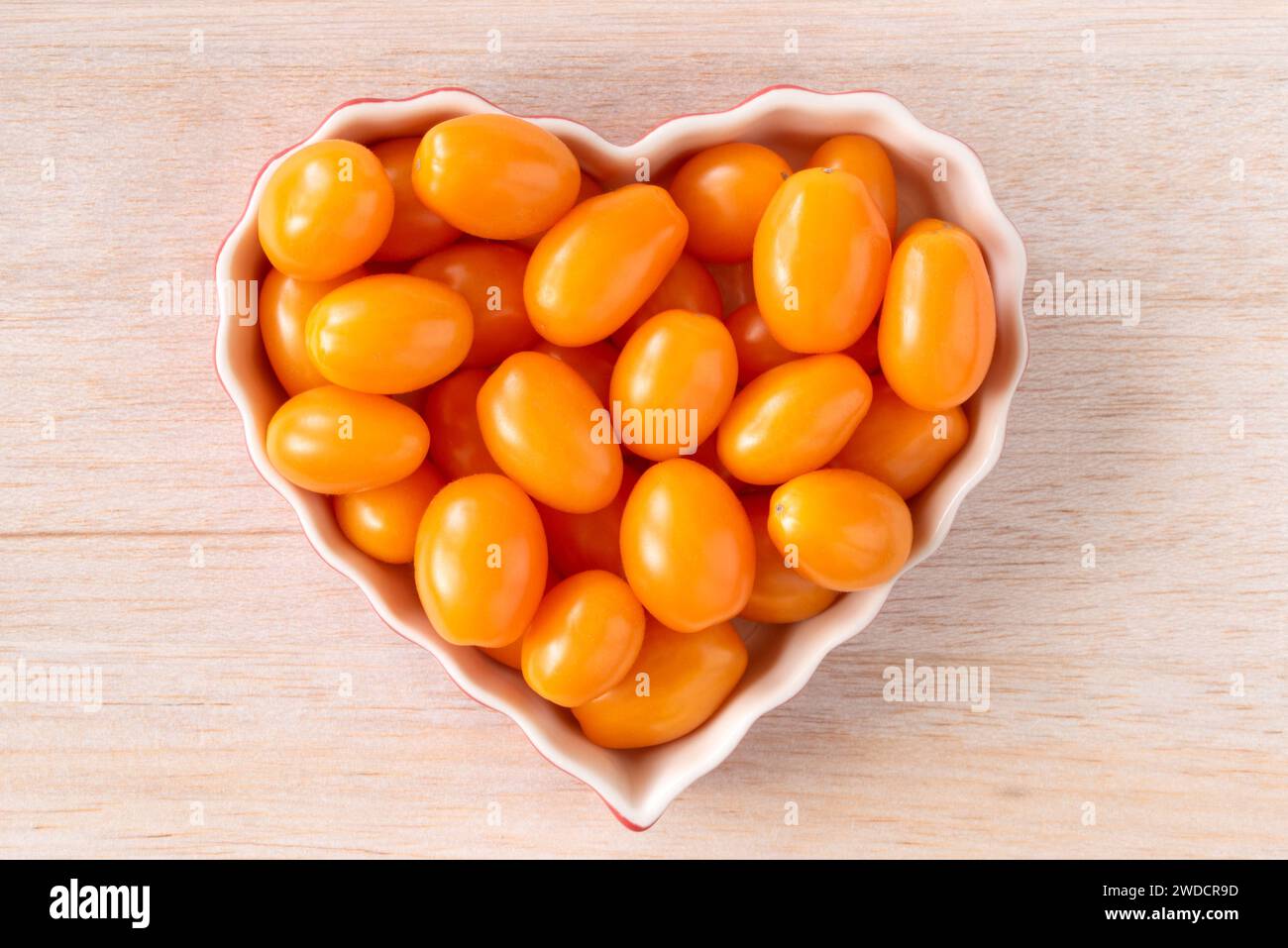 Orange Grape Tomatoes in a Heart Shape Stock Photo